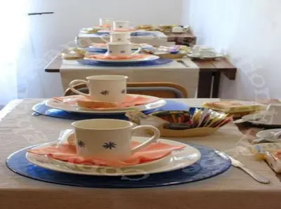 a table with three cups and plates on it at Aenea's B&B in Rome