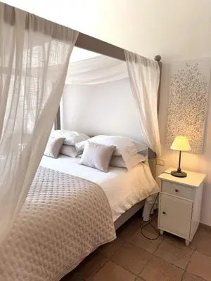 a bedroom with a white bed with a canopy at Aenea's B&B in Rome
