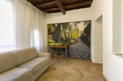 a living room with a couch and a painting on the wall at Trevi Little Palace #3 in Rome