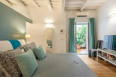 a bedroom with a bed and a living room at Trastevere Lovely Apartment in Rome