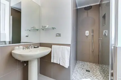 a bathroom with a sink and a shower at Rome Frattina27 in Rome