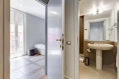 a bathroom with a sink and a toilet and a mirror at Rome Frattina27 in Rome