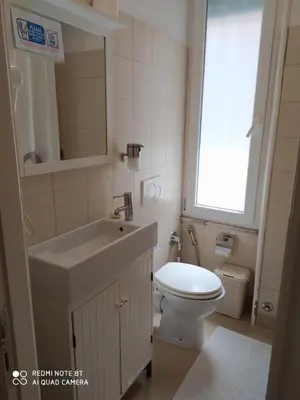 a bathroom with a sink and a toilet and a window at AL171 Tourist Rental close Metro B1 - Sant'Agnese Annibaliano in Rome