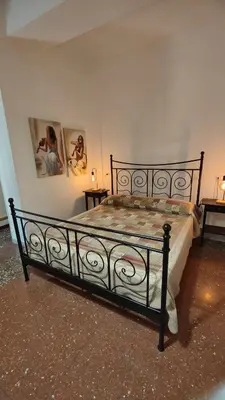 a bed in a bedroom with two pictures on the wall at AL171 Tourist Rental close Metro B1 - Sant'Agnese Annibaliano in Rome