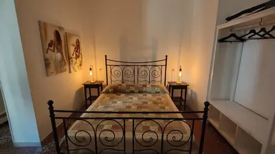 a bedroom with a black bed with two candles on two tables at AL171 Tourist Rental close Metro B1 - Sant'Agnese Annibaliano in Rome