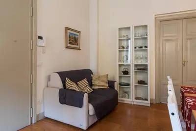a living room with a couch and some shelves at GuestHost - Bright & Roomy Apartment x6 - Trastevere District in Rome