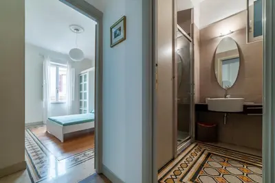 a bathroom with a sink and a mirror at GuestHost - Bright & Roomy Apartment x6 - Trastevere District in Rome