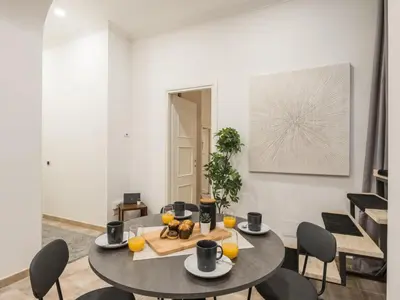 a dining room with a table and chairs at The Best Rent - Gorgeous one-bedroom apartment near Piazza di Spagna in Rome