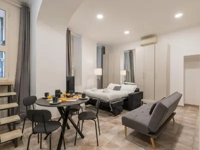 a living room with a bed and a table and chairs at The Best Rent - Gorgeous one-bedroom apartment near Piazza di Spagna in Rome