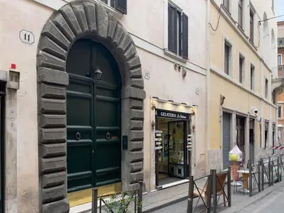 a building with a green door on a street at The Best Rent - Gorgeous one-bedroom apartment near Piazza di Spagna in Rome