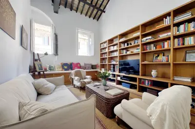 a living room with a couch and a book shelf at Ottavia Terrace in Rome