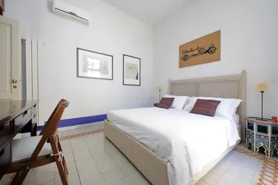 a white bedroom with a large white bed in it at Ottavia Terrace in Rome