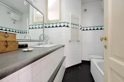 a white bathroom with a sink and a toilet at Ottavia Terrace in Rome