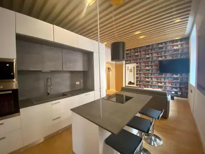 a kitchen with white cabinets and a black counter top at Prestige Apartment Nazionale in Rome