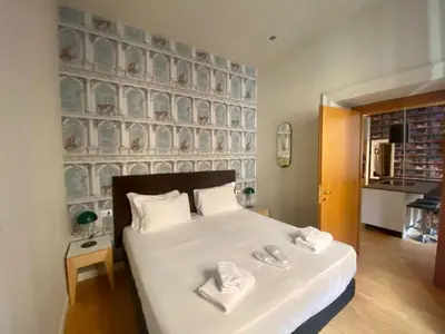 a bedroom with a large white bed with towels on it at Prestige Apartment Nazionale in Rome