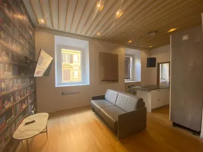 a living room with a couch and a table at Prestige Apartment Nazionale in Rome