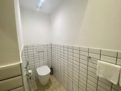 a white bathroom with a toilet and a tub at Prestige Apartment Nazionale in Rome