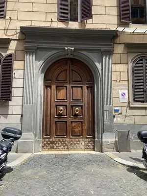 a large wooden door on the side of a building at Prestige Apartment Nazionale in Rome