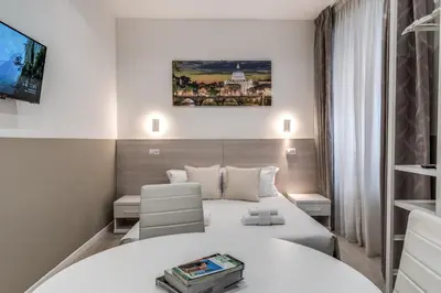 a hotel room with a bed and a chair at A Touch of Rome Guesthouse in Rome