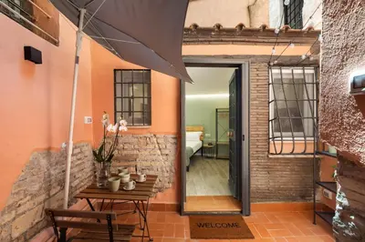 a room with a table and an open door at Pellegrino 113 in Rome