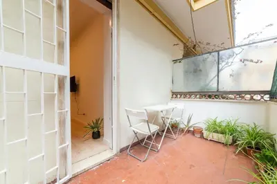 a patio with two chairs and a table and a window at Casa Villa Pamphili in Rome