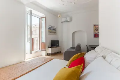 a living room with a white couch and a tv at Boutique Apartment 29 in Rome