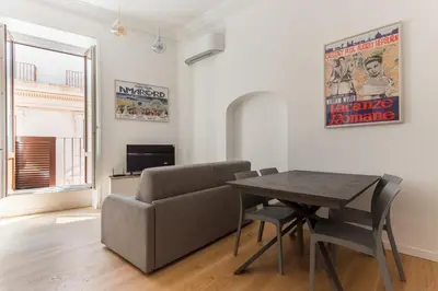 a living room with a dining room table and a couch at Boutique Apartment 29 in Rome