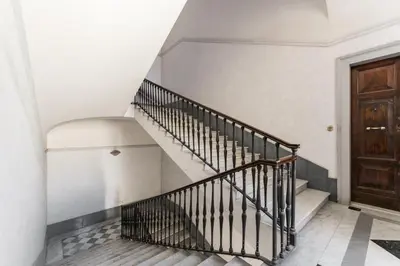 a staircase in a house with a wooden door at Boutique Apartment 29 in Rome