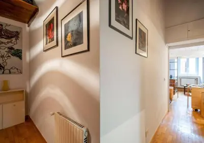 a hallway with paintings on the walls of a house at [Trastevere - Rome] Strategic and Comfortable Loft in Rome