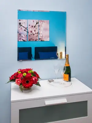 a table with a bottle of wine and a vase of flowers at B&B Eternal Rome Inn in Rome