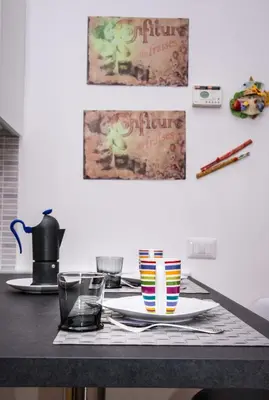 a table with two plates and cups and a pitcher at B&B Eternal Rome Inn in Rome