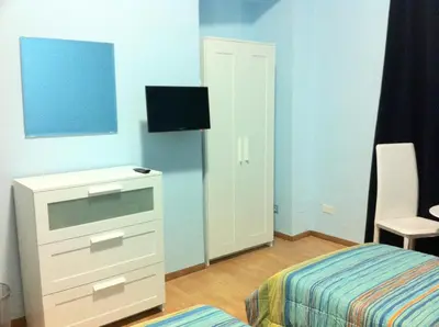 a bedroom with a bed and a dresser with a tv at B&B Eternal Rome Inn in Rome