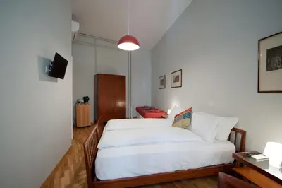 a bedroom with a large white bed in a room at Cassiodoro19 in Rome