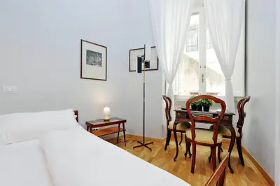a bedroom with a bed and a table and chairs at Cassiodoro19 in Rome
