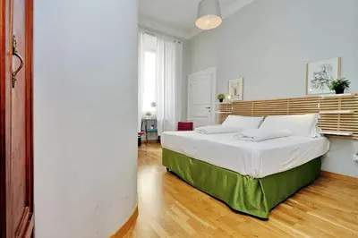 a bedroom with a large bed with white sheets at Cassiodoro19 in Rome