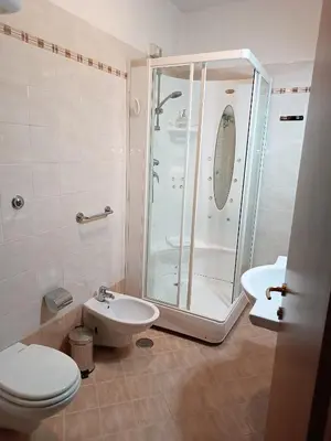 a bathroom with a shower and a toilet and a sink at Opera Italian Suite in Rome