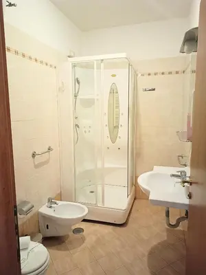 a bathroom with a shower and a toilet and a sink at Opera Italian Suite in Rome
