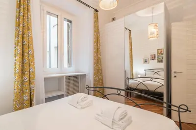 a bedroom with a bed and a mirror at The Best Rent - Three-Bedroom apartment near Villa Borghese in Rome