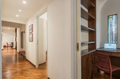 a hallway with a table and a laptop on a desk at The Best Rent - Three-Bedroom apartment near Villa Borghese in Rome