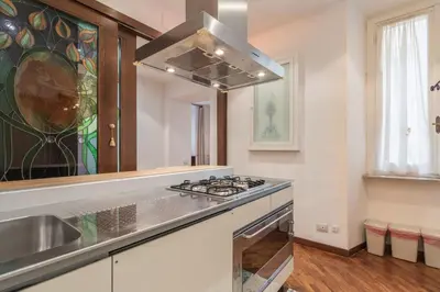 a kitchen with a stove top oven next to a window at The Best Rent - Three-Bedroom apartment near Villa Borghese in Rome
