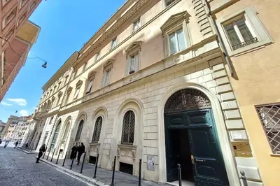 a large building with a black door on a street at Suite Barberini in Rome