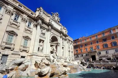 a building with a fountain in front of a building at Suite Barberini in Rome