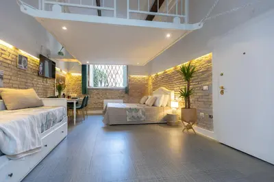a bedroom with a bed and a desk in a room at Casa Vinia in Rome