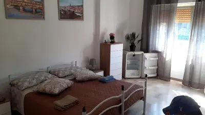 a bedroom with a bed and a dresser and a window at CorneliaGuestHouse in Rome