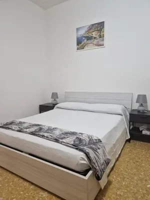 a bed in a bedroom with two night stands and two lamps at CorneliaGuestHouse in Rome