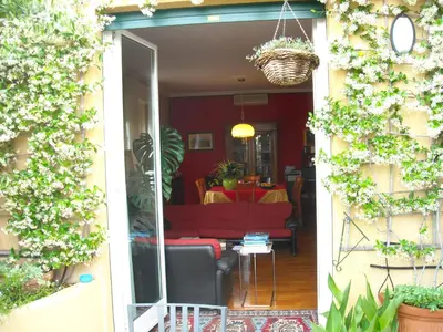 a living room with a red couch and a table at Attico Monteverde in Rome