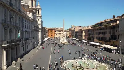 a large group of people walking down a city street at Attico Monteverde in Rome