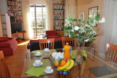 a living room with a glass table with fruit on it at Attico Monteverde in Rome