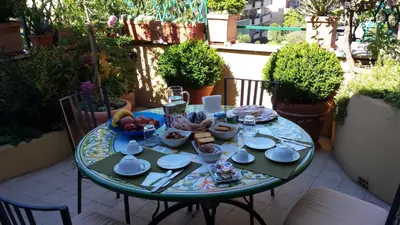 a table with a plate of food on a patio at Attico Monteverde in Rome