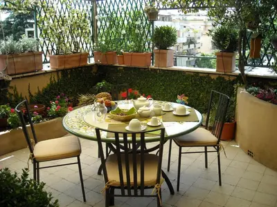 a table and chairs sitting on a patio at Attico Monteverde in Rome